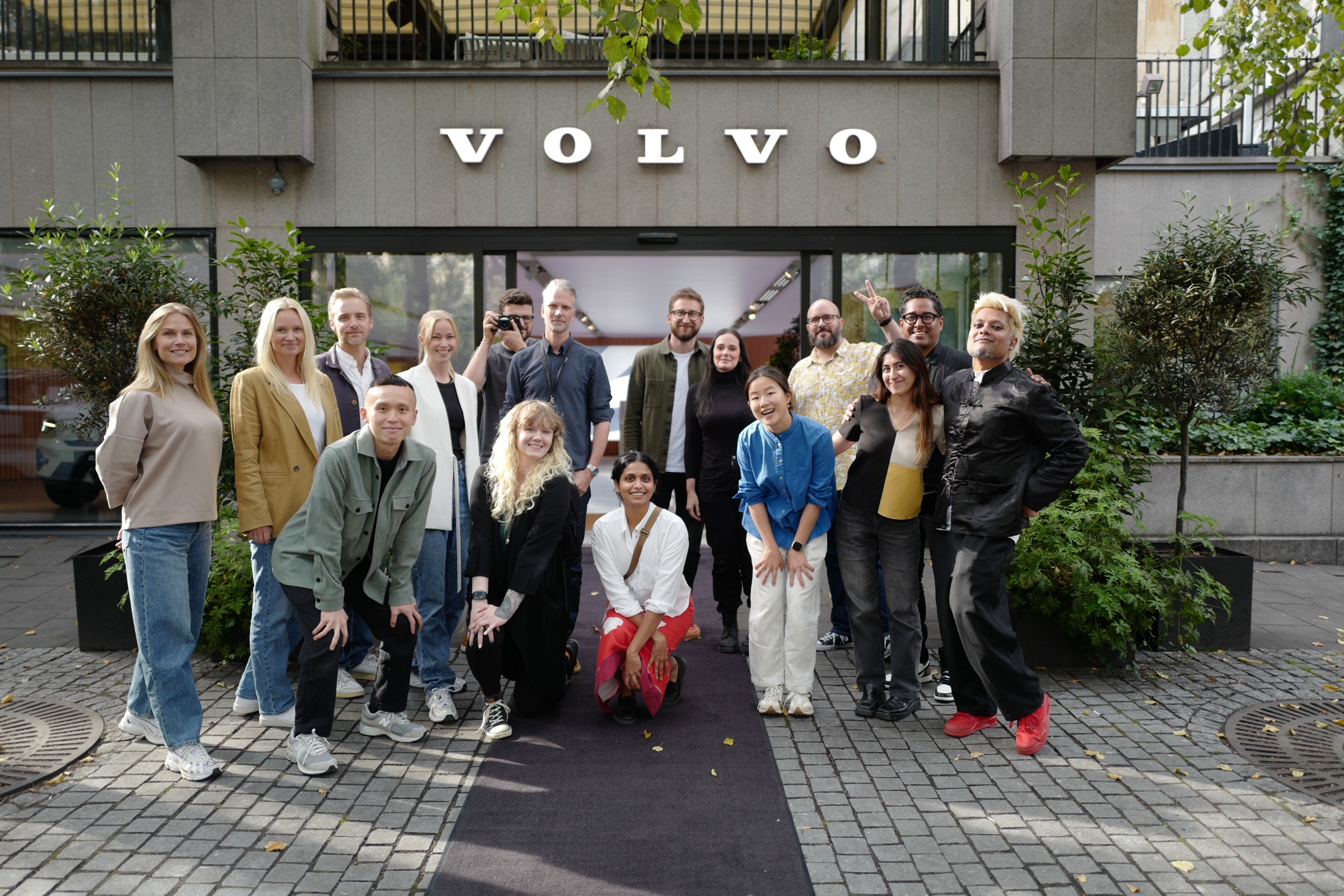 The UX team gathered outside a Volvo building.